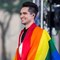 Panic! At the Disco front man Brendon Urie with a gay pride flag wrapped around his shoulders